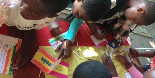 Picture: Children colouring the Zimbabwean and the Spanish flags.